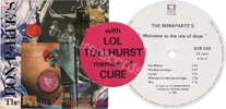 Welcome to the isle of dogs (issued 1986). Pink round sticker stating misspelt titles "with LOL TOLLHURST member of CURE". - Thanks to easyjeje